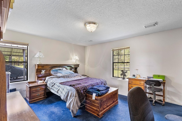 carpeted bedroom with a textured ceiling