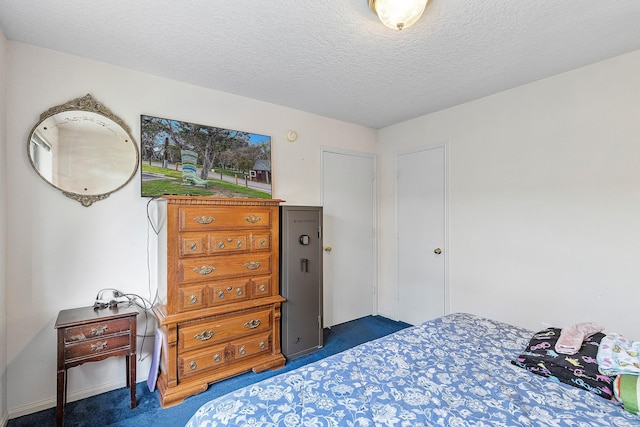 carpeted bedroom with a textured ceiling