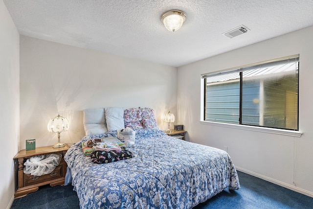 bedroom featuring carpet flooring and a textured ceiling