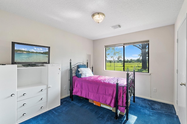 carpeted bedroom with a textured ceiling