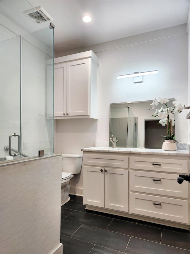 full bath with tile patterned flooring, toilet, vanity, visible vents, and a shower stall