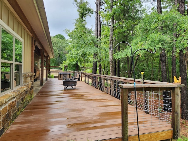 wooden terrace with a fire pit