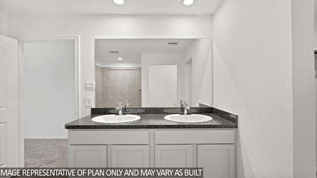 bathroom with a shower and vanity