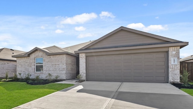 ranch-style home featuring a garage and a front yard