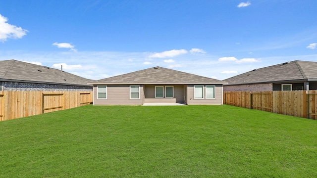 rear view of property featuring a yard