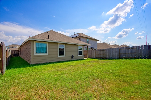 back of house with a yard