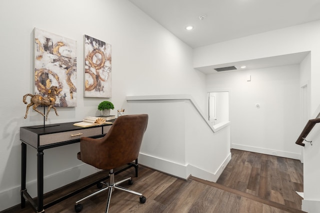 office featuring visible vents, baseboards, and wood finished floors