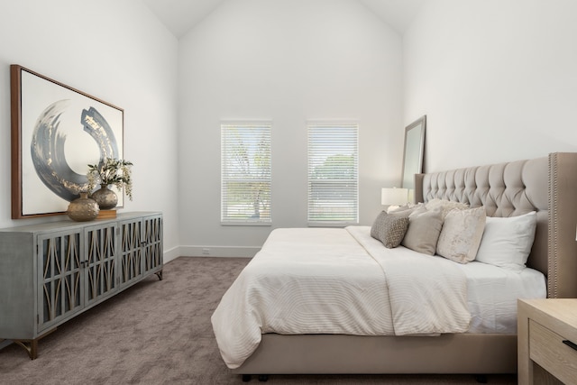 bedroom with high vaulted ceiling, carpet flooring, and baseboards