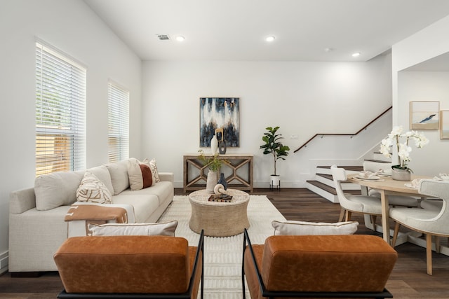 living area with visible vents, stairway, wood finished floors, and recessed lighting