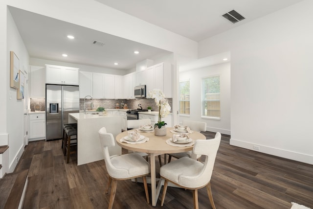 dining space with baseboards, visible vents, dark wood finished floors, and recessed lighting