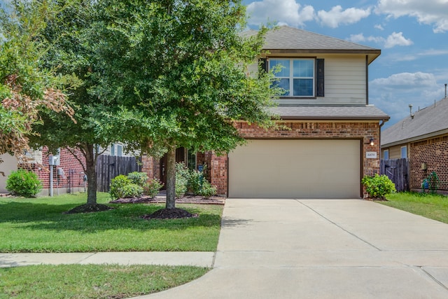 view of front of property with a garage and a front lawn