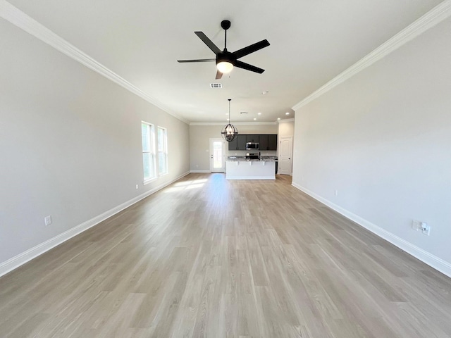 unfurnished living room featuring light wood-style flooring, visible vents, baseboards, ornamental molding, and a ceiling fan