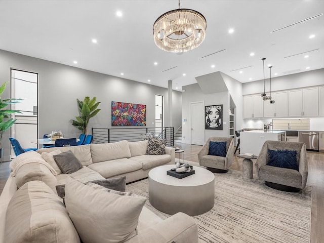 living room featuring a notable chandelier and light hardwood / wood-style floors