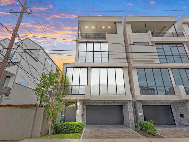 exterior space with a balcony and a garage