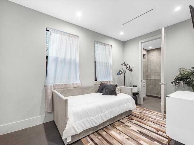 bedroom featuring wood-type flooring and ensuite bath