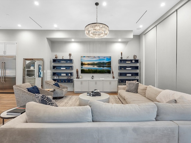 living room with a chandelier and light hardwood / wood-style floors