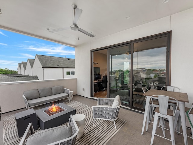 view of patio with an outdoor living space with a fire pit and ceiling fan