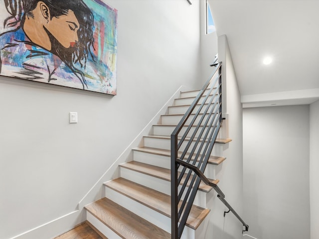 stairs with hardwood / wood-style floors