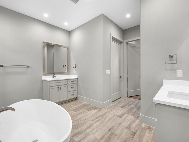 bathroom with vanity and hardwood / wood-style floors