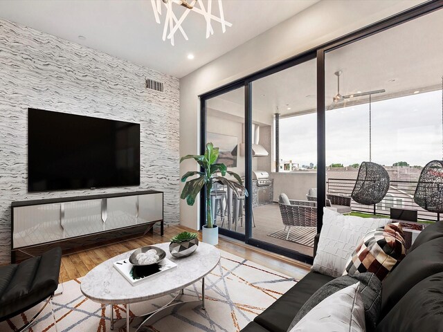 living room featuring hardwood / wood-style flooring and an inviting chandelier