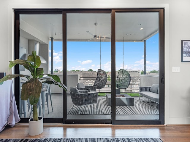 doorway to outside with ceiling fan and wood-type flooring