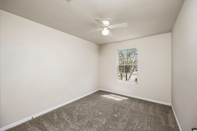 carpeted empty room featuring ceiling fan and a textured ceiling