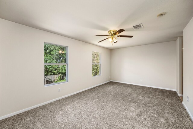 carpeted empty room featuring ceiling fan