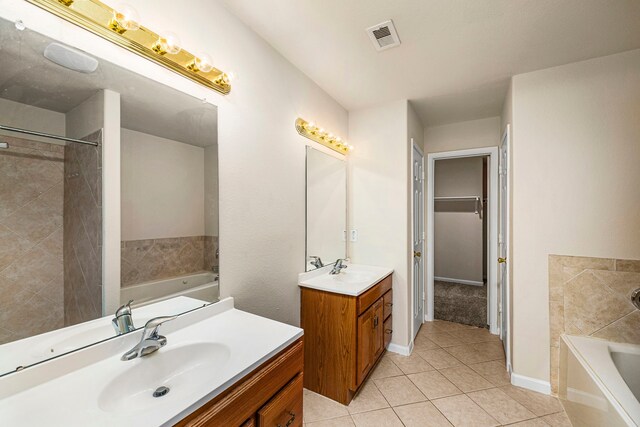 bathroom with vanity, tile patterned floors, and a washtub