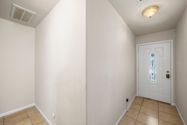 doorway to outside featuring light tile patterned floors