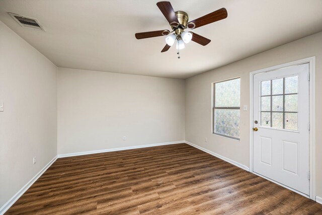 interior space with ceiling fan and dark hardwood / wood-style flooring