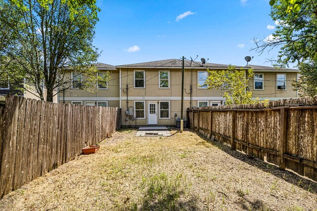 back of property featuring central AC unit