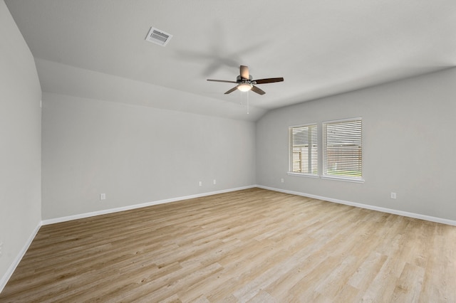 unfurnished room featuring ceiling fan, vaulted ceiling, and light hardwood / wood-style floors