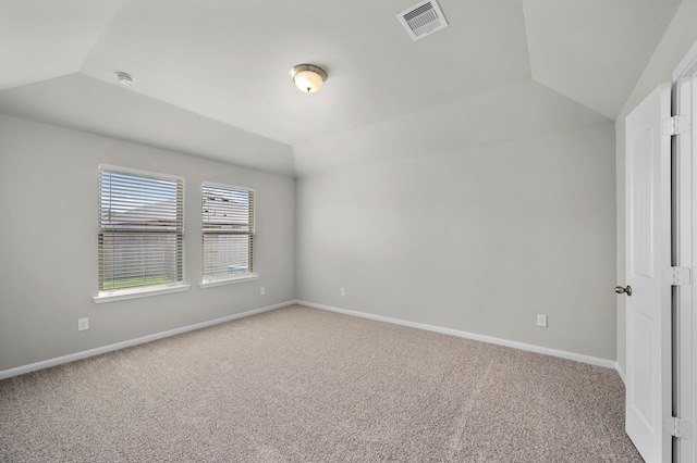 unfurnished room with carpet and vaulted ceiling