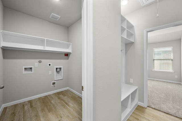 clothes washing area featuring washer hookup, hookup for a gas dryer, light hardwood / wood-style flooring, and electric dryer hookup