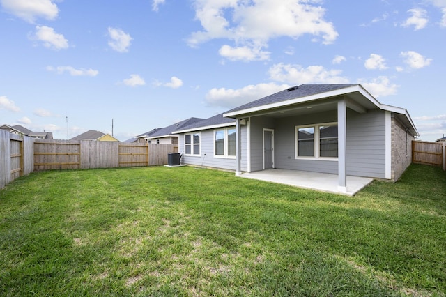 rear view of house featuring central AC unit, a patio, and a lawn