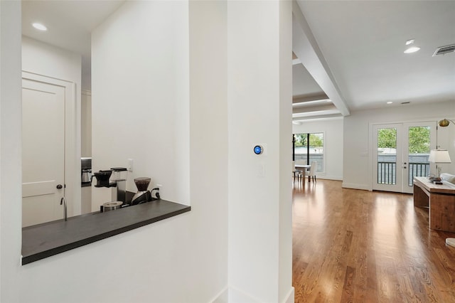 hall featuring hardwood / wood-style floors and french doors