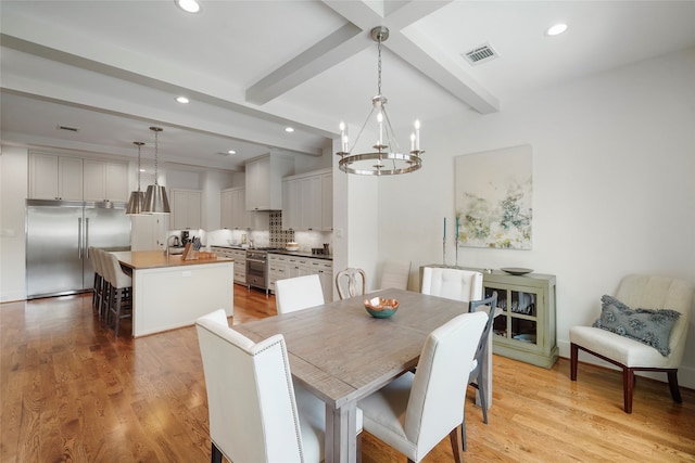 dining space featuring beamed ceiling, light wood-type flooring, and a notable chandelier