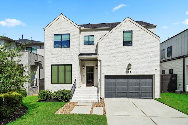 view of front of house featuring a front yard and a garage