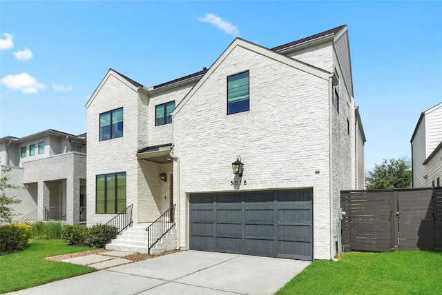 view of front of house featuring a garage and a front lawn