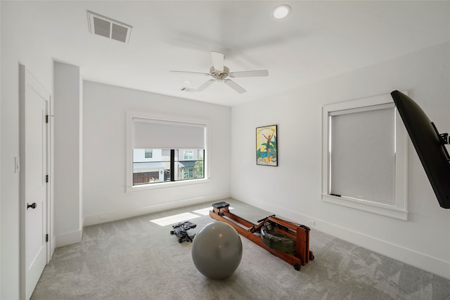 interior space featuring ceiling fan and light colored carpet