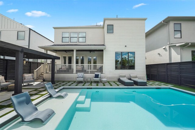 rear view of house featuring a pool side deck and ceiling fan