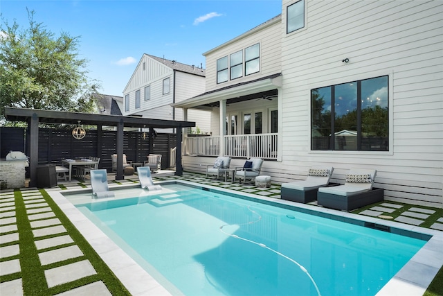 back of property with a fenced in pool, an outdoor hangout area, and a patio