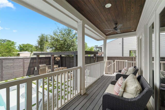 wooden deck featuring ceiling fan