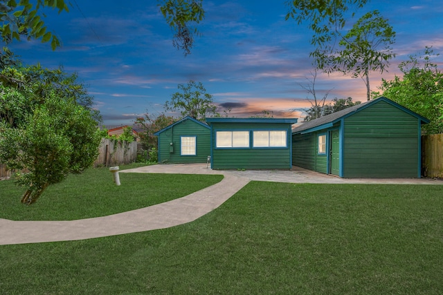 ranch-style home with a yard and a patio