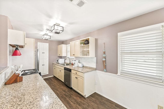 kitchen with sink, light stone counters, appliances with stainless steel finishes, and dark wood-type flooring