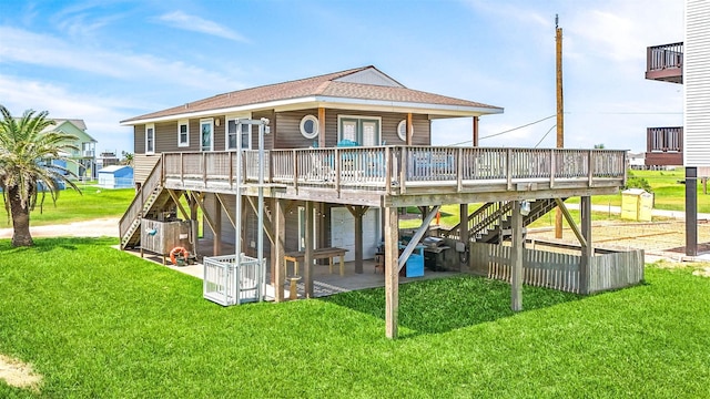 view of play area featuring a deck, a yard, stairway, and a patio area