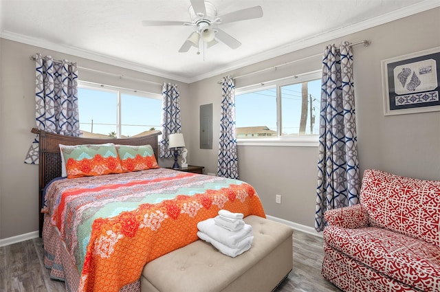 bedroom with multiple windows, wood finished floors, and crown molding