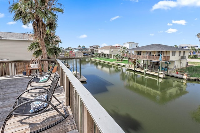 view of dock featuring a residential view and a water view