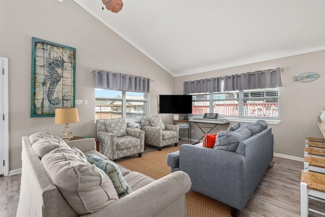 living area featuring high vaulted ceiling, baseboards, wood finished floors, and ornamental molding