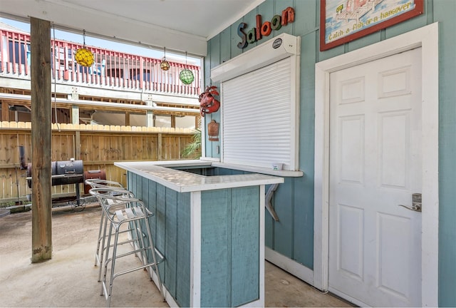 kitchen with concrete floors and a kitchen breakfast bar